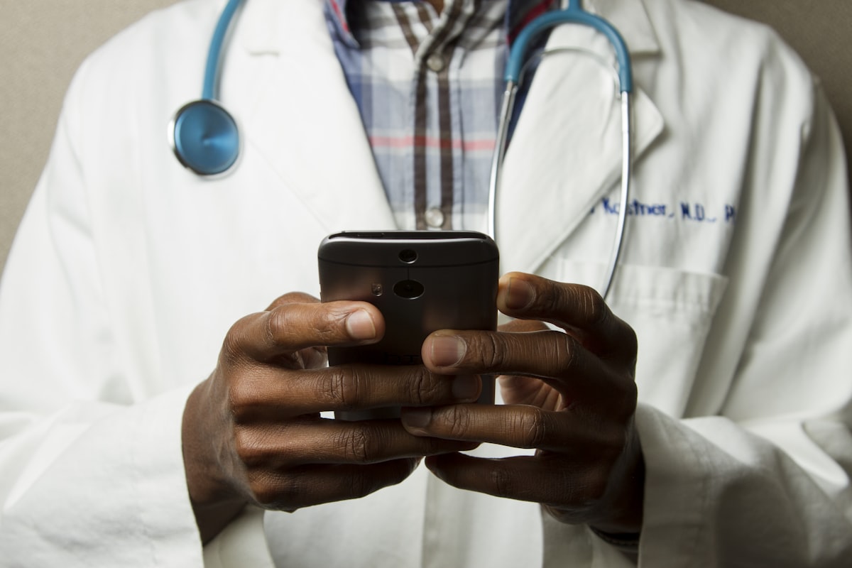 A clinician reviewing information on a phone