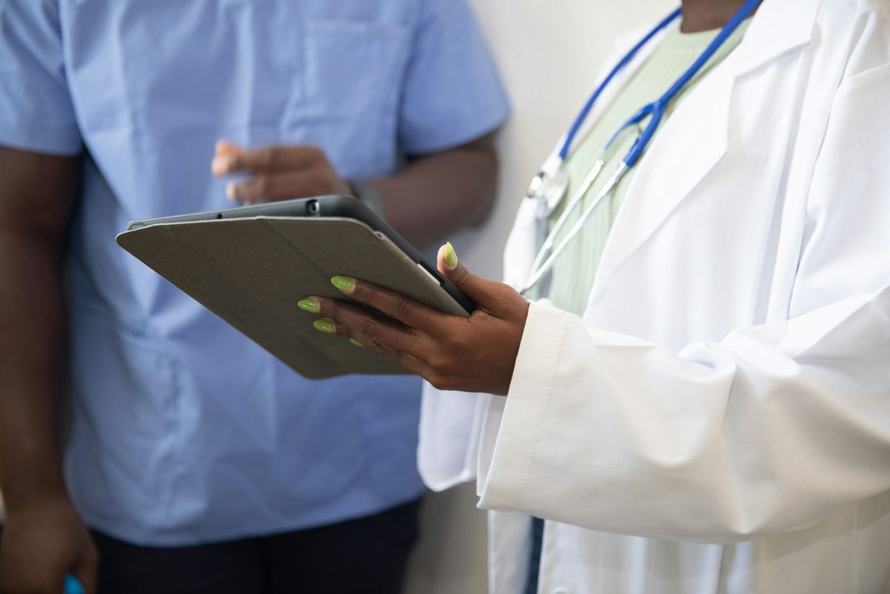 A clinical team reviewing patient information together on a tablet